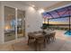 Stylish patio dining area with seating for eight, offering stunning sunset views at 508 Blue Shell Loop, Sarasota, FL 34240