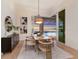 Beautiful dining room with a marble table, comfortable chairs, and sliding doors offering stunning pool and lake views at 508 Blue Shell Loop, Sarasota, FL 34240