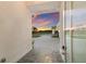 A beautiful sunset view through the front door, highlighting the lovely driveway and landscaping at 508 Blue Shell Loop, Sarasota, FL 34240