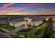 Scenic aerial view of a home with a three-car garage, lovely landscaping and beautiful water views at 508 Blue Shell Loop, Sarasota, FL 34240
