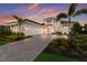 Inviting home with a paver driveway, three-car garage, and lush landscaping at 508 Blue Shell Loop, Sarasota, FL 34240