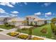 Stunning exterior elevation with manicured lawn, beautiful landscaping, and a large three-car garage at 508 Blue Shell Loop, Sarasota, FL 34240