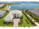 Gorgeous waterfront home featuring pristine landscaping and serene lake views under a sunny sky at 508 Blue Shell Loop, Sarasota, FL 34240