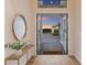 Inviting foyer with open doors leading to a beautiful driveway and serene water feature at sunset at 508 Blue Shell Loop, Sarasota, FL 34240