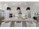 Stunning kitchen features a large island, pendant lighting, and stainless steel appliances at 508 Blue Shell Loop, Sarasota, FL 34240