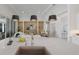 Bright, open kitchen with large island and counter seating flows seamlessly into a cozy living space at 508 Blue Shell Loop, Sarasota, FL 34240