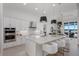 Gourmet kitchen with island seating, modern appliances, and views of the water at 508 Blue Shell Loop, Sarasota, FL 34240