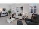 Stylishly designed living room with modern furniture, minimalist decor, and ample natural light at 508 Blue Shell Loop, Sarasota, FL 34240