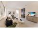 Cozy living room with stylish furniture, TV, and access to outdoor view at 508 Blue Shell Loop, Sarasota, FL 34240
