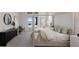 Spacious main bedroom suite with serene decor, access to outdoor space, and water views at 508 Blue Shell Loop, Sarasota, FL 34240