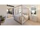 Elegant main bedroom boasts a canopy bed, cozy textures, and serene access to outdoor screened-in porch at 508 Blue Shell Loop, Sarasota, FL 34240