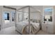 Serene main bedroom with a four-poster bed, plantation shutters, and tranquil waterfront views at 508 Blue Shell Loop, Sarasota, FL 34240