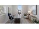 Bright office with a large window, modern desk, comfortable chair, and minimalist decor for a productive workspace at 508 Blue Shell Loop, Sarasota, FL 34240