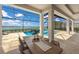 Enclosed outdoor dining area with a large table overlooking the pool and lake at 508 Blue Shell Loop, Sarasota, FL 34240