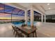 Outdoor dining area with views of the lake, pool, and lush landscaping through the screened enclosure at 508 Blue Shell Loop, Sarasota, FL 34240