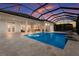 This luxury home features a large pool with travertine tile and a screened enclosure for outdoor enjoyment at 508 Blue Shell Loop, Sarasota, FL 34240