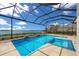 Relax by the pool with beautiful lake views from the screened enclosure at 508 Blue Shell Loop, Sarasota, FL 34240