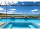 Enjoy the beautiful lake view from the screened pool and spa area at 508 Blue Shell Loop, Sarasota, FL 34240