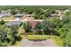 Aerial view of home with roof solar panels and surrounded by lush greenery in a serene neighborhood at 5168 Cillette Ave, North Port, FL 34288