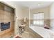 A bright bathroom featuring a walk-in shower, soaking tub, and travertine tile at 5168 Cillette Ave, North Port, FL 34288