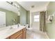 Well-lit bathroom featuring a single sink vanity with a tiled floor and shower-tub combo at 5168 Cillette Ave, North Port, FL 34288