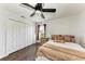 Bedroom features wood-look flooring, a ceiling fan, and closet at 5168 Cillette Ave, North Port, FL 34288