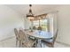 Dining room with decorative chandelier, large window view, and seating for six at 5168 Cillette Ave, North Port, FL 34288
