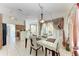 Bright dining area features a glass table, chandelier, and sliding glass doors to the lanai at 5168 Cillette Ave, North Port, FL 34288