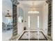 Elegant foyer with marble floors, decorative columns, and a stunning chandelier, creating a grand entrance at 5168 Cillette Ave, North Port, FL 34288