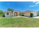 Charming single-story home featuring a well-manicured lawn, red roof, and inviting front entrance at 5168 Cillette Ave, North Port, FL 34288