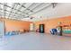 Spacious garage with ample storage, water heater, refrigerator and epoxied concrete flooring at 5168 Cillette Ave, North Port, FL 34288