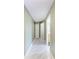 Hallway with tile flooring leading to a bathroom and closet at 5168 Cillette Ave, North Port, FL 34288