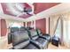 Luxurious home theater with plush seating, custom lighting, and a high-end sound system for immersive entertainment at 5168 Cillette Ave, North Port, FL 34288