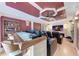 Entertainment area features theater seating, custom bar, and a large screen for an ultimate viewing experience at 5168 Cillette Ave, North Port, FL 34288