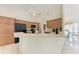 Bright kitchen with oak cabinets, black appliances, tile flooring, and a breakfast bar open to dining area at 5168 Cillette Ave, North Port, FL 34288