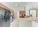 Open kitchen with oak cabinets, tile flooring, a breakfast bar, and modern appliances, perfect for cooking at 5168 Cillette Ave, North Port, FL 34288