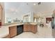 Bright, open kitchen with updated appliances, oak cabinets, a breakfast bar, and seamless flow to dining area at 5168 Cillette Ave, North Port, FL 34288