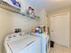 Laundry room with washer, dryer, shelving, and storage at 5168 Cillette Ave, North Port, FL 34288