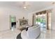Bright living room with a fireplace, ceiling fan, marble floors, and sliding glass doors to the outdoors at 5168 Cillette Ave, North Port, FL 34288