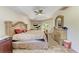 This large main bedroom features a tray ceiling, ceiling fan, and sliding glass door at 5168 Cillette Ave, North Port, FL 34288