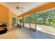 Enclosed patio with ceiling fan and backyard views at 5168 Cillette Ave, North Port, FL 34288