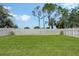 Spacious backyard with lush green grass and a white fence, offering privacy and plenty of room for outdoor activities at 5238 Aqua Breeze Dr, Bradenton, FL 34208