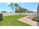 An expansive backyard featuring a lush green lawn, white fencing, and a brick patio perfect for outdoor relaxation and entertaining at 5238 Aqua Breeze Dr, Bradenton, FL 34208
