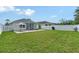 Enjoy a serene backyard with a green lawn, a screened lanai, and white fencing, providing an ideal outdoor living space at 5238 Aqua Breeze Dr, Bradenton, FL 34208