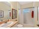 Bright bathroom featuring framed mirror, framed botanical art and shower-tub combination with white tiling at 5238 Aqua Breeze Dr, Bradenton, FL 34208
