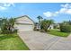 Well-maintained home with a two-car garage, lush landscaping, and a concrete driveway on a sunny day at 5238 Aqua Breeze Dr, Bradenton, FL 34208