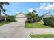 Well-maintained home with a two-car garage, lush landscaping, and a concrete driveway under a bright blue sky at 5238 Aqua Breeze Dr, Bradenton, FL 34208
