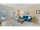 Bright living room featuring tile floors, comfortable seating, and a glass door that offers seamless outdoor access at 5238 Aqua Breeze Dr, Bradenton, FL 34208