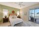 Tranquil bedroom with a ceiling fan, soft natural light, a sliding glass door, and access to the outdoor space at 5238 Aqua Breeze Dr, Bradenton, FL 34208