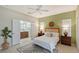 Airy main bedroom featuring an en-suite bathroom, ample natural light, and a ceiling fan for added comfort at 5238 Aqua Breeze Dr, Bradenton, FL 34208